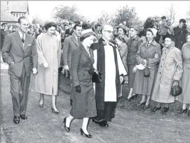  ??  ?? Crowds line the church approach as Her Majesty The Queen and Prince Phillip joined Lord and Lady Brabourne for a service conducted by Rector, the Rev H McDonald at Mersham Parish church on April 5, 1957