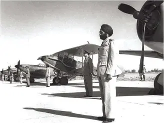  ??  ?? Sqn Ldr Meher Singh at the parade at Ambala before taking command of No.6 Squadron. Aircraft types at the background are (right to left) Vultee Vengeance, Audax and Hurricanes