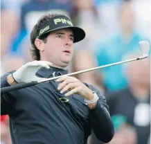  ?? Ross D. Franklin/The Associated Press ?? Bubba Watson lets go of his iron as he watches his tee shot on the seventh hole during the second round of the Phoenix Open.