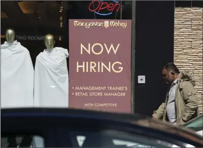  ?? (AP/Nam Y. Huh) ?? A hiring sign is displayed at a retail store in Chicago on Monday.