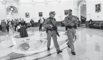  ?? Billy Calzada / Staff photograph­er ?? State law officers walk in the Texas Capitol as the Legislatur­e discusses permitless gun carry last week.