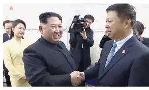  ?? — Reuters ?? Mending ties: A file image showing Song (right) shaking hands with Kim as Kim’s wife Ri Sol-ju looks on, on a train in Dandong, China.