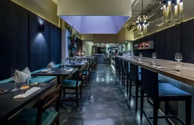  ??  ?? FEELING AT HOME With a marble chef’s table as a focal point, the interior of the restaurant is designed to make diners feel like they are in a home kitchen