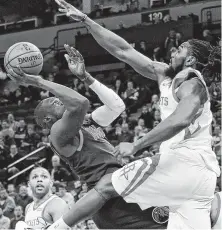  ?? Jim Mone / Associated Press ?? The Timberwolv­es’ Luol Deng, left, falls away as he shoots over the Rockets’ Nene in the first half Wednesday night.