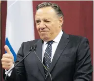 ?? JACQUES BOISSINOT / THE CANADIAN PRESS ?? Quebec Premier François Legault gives the thumbs up at Thursday’s swearing-in ceremony in Quebec City.