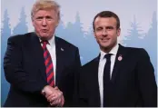  ?? — AFP ?? US President Donald Trump and French President Emmanuel Macron shake hands before a meeting on the sidelines of the G7 Summit in La Malbaie, Quebec, on Friday.