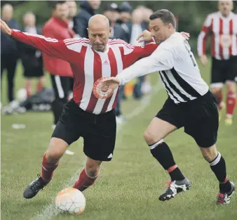  ??  ?? John Hogg Funerals (red and white) battle against Blakelaw SC in the Over-40s League last week