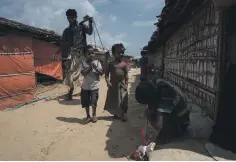  ?? Campbell MacDiarmid / The National ?? From top, Rohingya refugees sell vegetables in a camp near Cox’s Bazar, Bangladesh; a young Rohingya refugee in a camp; most men fled their village when Myanmar soldiers attacked last August; children playing near the camp