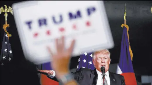  ?? CARLO ALLEGRI/REUTERS ?? Republican presidenti­al nominee Donald Trump speaks at Wings Over the Rockies Air and Space Museum during a campaign rally in Denver on Friday. Trump has alarmed GOP foreign policy experts with his suggestion­s of what he would do as president.