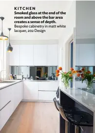  ??  ?? KITCHEN
Smoked glass at the end of the room and above the bar area creates a sense of depth. Bespoke cabinetry in matt white lacquer, 202 Design