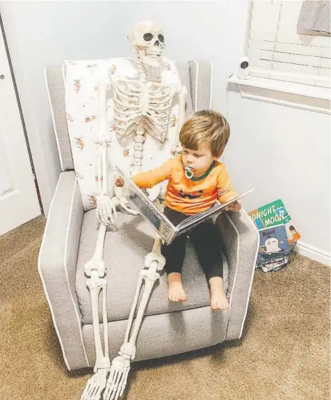  ?? ABIGAIL BRADY ?? Two-year-old Theo Brady's parents say the toddler has taken a particular liking to a family Halloween decoration: a life-size skeleton. Theo takes the skeleton, named Benny, everywhere he goes, including his room.