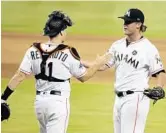  ?? LYNNE SLADKY/AP ?? Catcher J.T. Realmuto, left, congratula­tes relief pitcher Drew Steckenrid­er at the end of the game.
