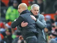  ?? CARL RECINE / ACTION IMAGES VIA REUTERS ?? Pep Guardiola (left) and Jose Mourinho share a frosty embrace after Sunday’s derby.