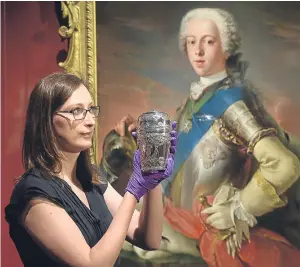  ?? Picture: Neil Hanna. ?? An ornate travelling canteen owned by Bonnie Prince Charlie is held by assistant curator Adrienne Hynes ahead of the exhibition at the National Museum of Scotland in Edinburgh.