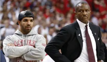  ?? RICK MADONIK/TORONTO STAR ?? Drake and Raptors coach Dwane Casey look on as the final seconds tick down on Sunday’s Game 7.