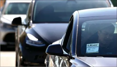  ?? MARIO TAMA — GETTY IMAGES ?? Should you be involved in an accident while riding in an Uber, it’s important to have the driver report the incident to Uber Safety.