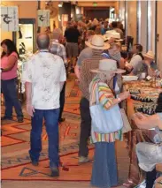  ??  ?? Visitors browse through booths at Brian Lebel’s Cody Old West Show & Sale in 2018.