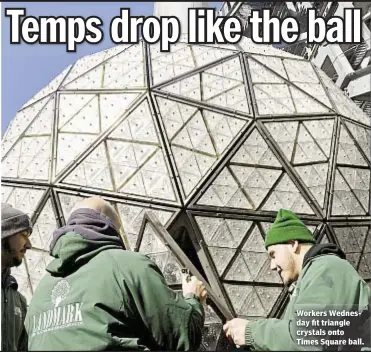  ??  ?? Workers Wednesday fit triangle crystals onto Times Square ball.