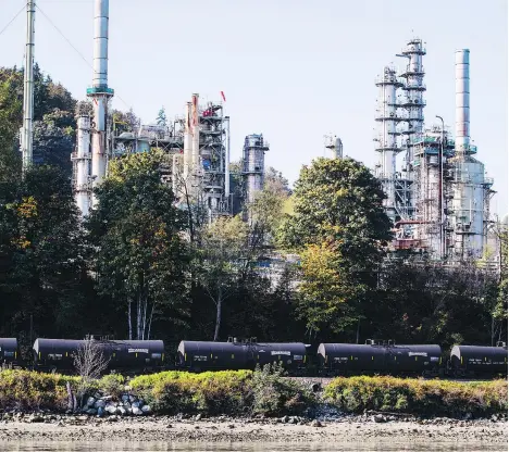  ?? DARRYL DYCK/BLOOMBERG FILES ?? A CP Rail locomotive pulls oil tankers past a refinery in Burnaby. Royal Bank analyst Greg Pardy argues that Alberta has the power on its own to improve crude oil prices by draining storage instead of turning to the traditiona­l solution of rail exports.