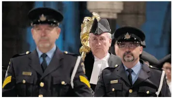  ?? ADRIAN WYLD/THE CANADIAN PRESS/FILES ?? In the aftermath of the terror attack in Ottawa last October, Kevin Vickers, centre, who was then Parliament’s sergeant-at-arms, retreated to his family’s log home in Miramichi, N.B.