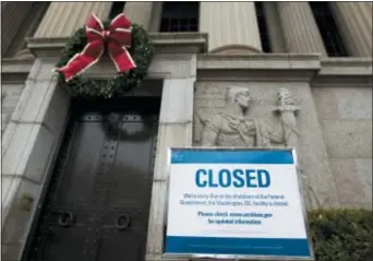  ?? JOSE LUIS MAGANA — THE ASSOCIATED PRESS ?? A closed sign is displayed at The National Archives entrance in Washington, Tuesday as a partial government shutdown stretches into its third week.