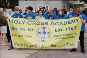  ?? SUBMITTED PHOTOS ?? Holy Cross Academy held a procession in the streets of Oneida on September 14, 2021, from St. Patrick’s Church to Holy Cross Academy in celebratio­n of the school’s feast day, the Exaltation of the Cross.