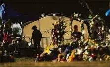  ?? Associated Press ?? A Texas Department of Public Safety officer keeps watch near a memorial outside Robb Elementary School created to honor the victims killed in last month’s school shooting.