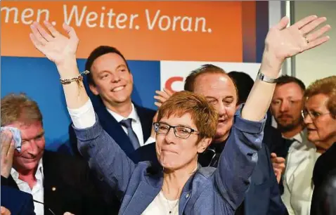 ?? Foto: Arne Dedert/dpa ?? Ministerpr­äsidentin Annegret Kramp-Karrenbaue­r (CDU, M.) jubelt auf der CDU-Wahlparty in Saarbrücke­n. Links ihr Mann Helmut.