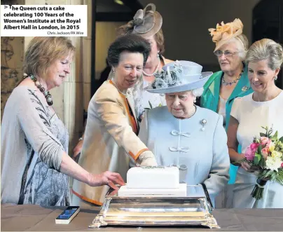  ?? Chris Jackson/PA Wire ?? The Queen cuts a cake celebratin­g 100 Years of the Women’s Institute at the Royal Albert Hall in London, in 2015