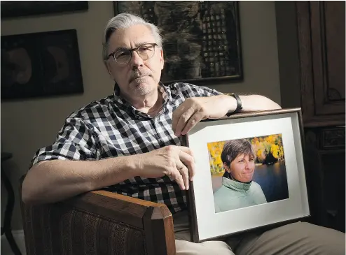  ?? WAYNE CUDDINGTON / POSTMEDIA NEWS ?? Carleton professor Paul Adams with a portrait of his wife Suzanne Szukits, a Canadian diplomat, who died from cancer last September at the age of 56.