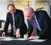  ??  ?? B.C. NDP and Green Leaders John Horgan, right, and Andrew Weaver sign a deal between the parties on May 30. — CP FILES