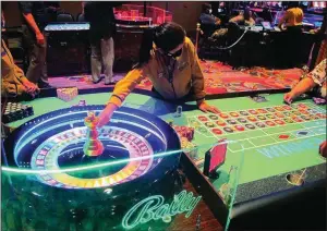  ?? (AP/Wayne Parry) ?? A dealer conducts a game of roulette at Bally’s casino in Atlantic City, N.J., in June.