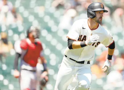  ?? Scott Strazzante / The Chronicle ?? Giants outfielder Steven Duggar, tripling against Arizona at Oracle Park on June 17, is having a career season after an offseason working out with A’s first baseman Matt Olson in Atlanta.