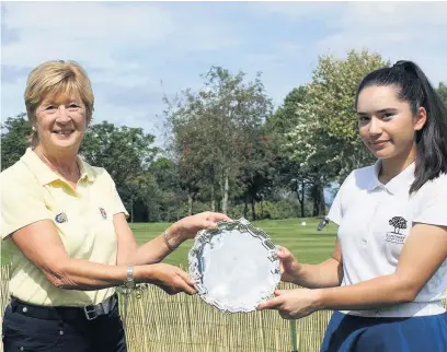  ??  ?? Frances Gell, left, presents Siobhan with the trophy after victory in the Margaret Sangster Salver