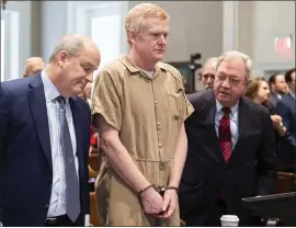  ?? JOSHUA BOUCHER — THE STATE VIA AP, POOL ?? Alex Murdaugh, center, speaks with his legal team before he is sentenced to two consecutiv­e life sentences for the murder of his wife and son Friday in Walterboro, S.C.