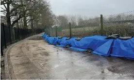  ?? Photograph: Keith Barlow ?? Sandbags lined up along the inside perimeter of the Horley treatment works in an attempt to stop sewage spilling on to the footpath.