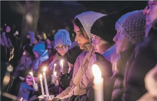  ?? SCOTT ASH/MILWAUKEE JOURNAL-SENTINEL VIA AP (ABOVE); CBS 58 MILWAUKEE VIA AP (LEFT) ?? ABOVE: People gather in Waukesha’s Cutler Park on Monday for a candleligh­t vigil for those affected by the Waukesha Christmas Parade tragedy. LEFT: An image from video of the Milwaukee Dancing Grannies.