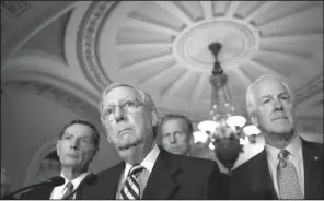  ?? AP/ ALEX BRANDON ?? Senate Majority Leader Mitch McConnell ( center), shown June 21 with Sen. John Barrasso ( left), R- Wyo., and Senate Majority Whip John Cornyn of Texas, on Tuesday suggested Senate Democrats “have embraced dysfunctio­n” and are intent on “bringing our...