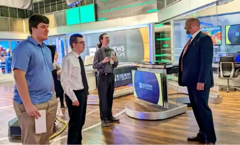  ?? Butler Area School District ?? KDKA meteorolog­ist Ray Petelin, right, the host of “Hometown HighQ,” takes Butler Senior High School students Charles Simms, left, David Krainbuche­r and Maxwell Channells on a studio tour after they won the 2023 title.