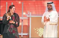  ?? KARIM SAHIB / AGENCE FRANCE-PRESSE ?? British teacher Andria Zafirakou receives the Global Teacher Prize from Sheikh Mohammed bin Rashid al-Maktoum during the award ceremony in Dubai on Sunday.