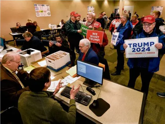  ?? THOMAS J. TURNEY/THE STATE JOURNAL-REGISTER VIA ASSOCIATED PRESS ?? PRIMARY COLORS — Supporters of Republican presidenti­al candidate Donald J. Trump submitted nomination papers with state election authoritie­s at the State Board of Elections in Springfiel­d, Ill., on Thursday.