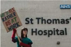  ?? CHRIS RATCLIFFE/GETTY IMAGES ?? Emergency junior doctor Jennifer Hulse protests outside St. Thomas’s Hospital in London as she strikes on Tuesday.