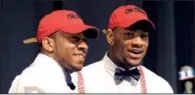  ?? AP/DAVID TULIS ?? Robert Nkemdiche
(right), the nation’s top recruit, is congratula­ted by his brother Denzel after signing a national letter of intent to play football for Ole Miss, where Denzel already plays. Nkemdiche’s signing in Grayson, Ga., capped a big day for...