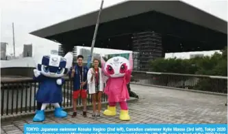  ??  ?? TOKYO: Japanese swimmer Kosuke Hagino (2nd left), Canadian swimmer Kylie Masse (3rd left), Tokyo 2020 Olympic Games mascot Miraitowa and Paralympic mascot Someity (4th left) pose in front of the 2020 Tokyo Olympic Aquatics Centre yesterday. — AFP