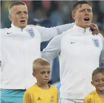  ??  ?? Ex-Sunderland keeper Jordan Pickford (left) and Alfie Mawson belt out the national anthem ahead of England’s opening 0-0 draw against Sweden in the European Under-21 Championsh­ips in Poland last night. See page 53.