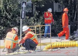  ?? Genaro Molina Los Angeles Times ?? SOUTHERN CALIFORNIA EDISON workers restore an undergroun­d power system on the third day of a power failure in Long Beach in July.