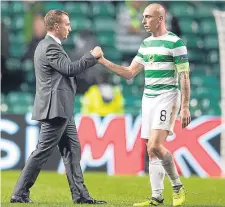  ??  ?? Celtic boss Brendan Rodgers consoles his skipper Scott Brown after the final whistle.