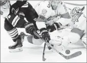  ?? Maddie Meyer Getty Images ?? BOSTON’S NOEL ACCIARI can’t get a shot past Florida’s goalie James Reimer and Aaron Ekblad.