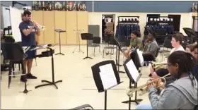  ?? PHOTO COURTESY OF JOHN ARMATO ?? Pottstown High School’s newband director, David Bonilla-Garcia, workswith the horn section as marching band practices get underway.