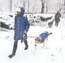  ?? BOB KARP/USA TODAY NETWORK ?? Barbara Devito and Cotee, front, and Marilyn Cuykendall with Gussie brave the snow in Morristown, N.J.